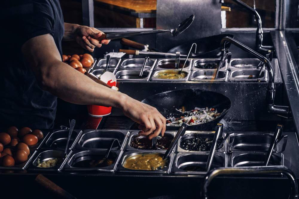 cooking-process-asian-restaurant-cook-is-fry-vegetables-with-spices-sauce-wok